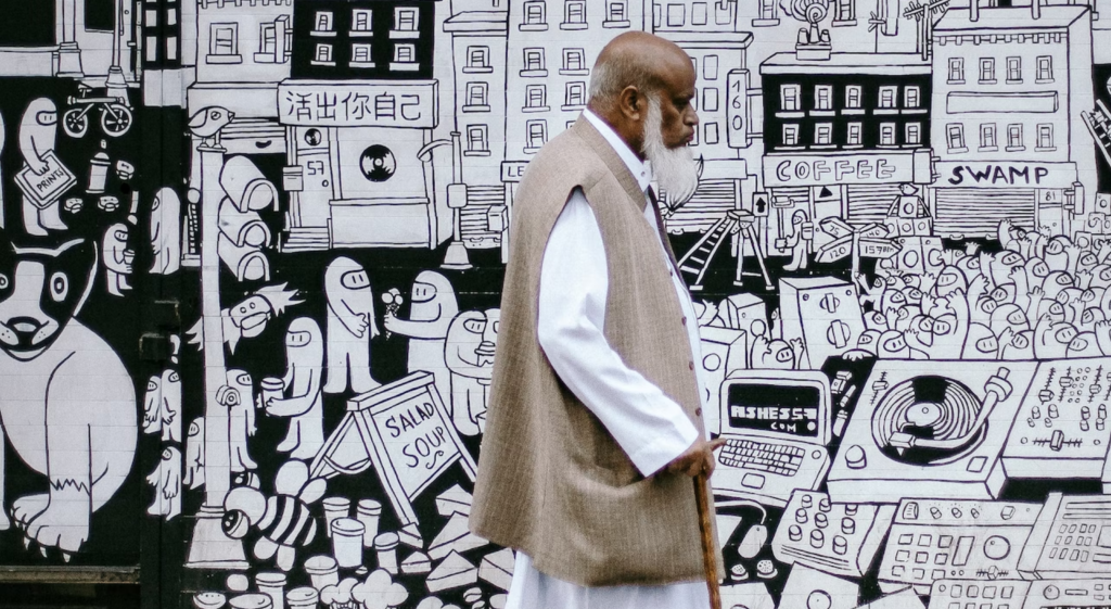 image showing man walking in front of black and white illustrations showing how you can reflect diversity in your livery websites imagery