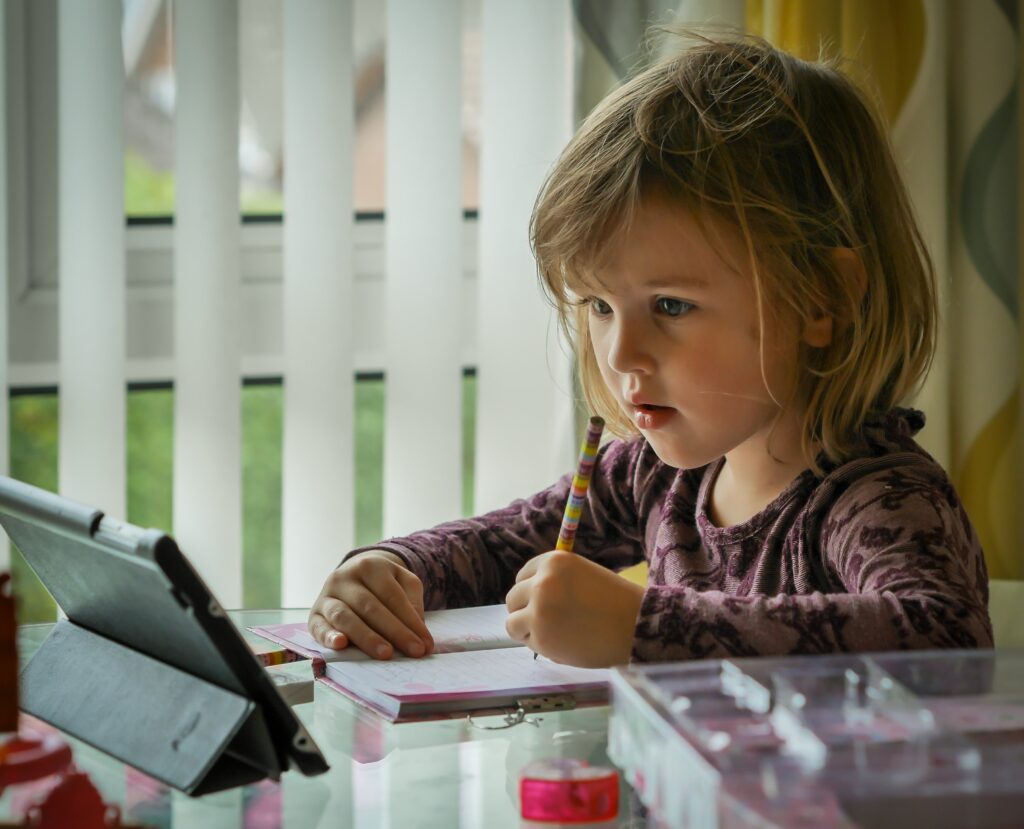 image showing child learning using a tablet for a virtual school experience