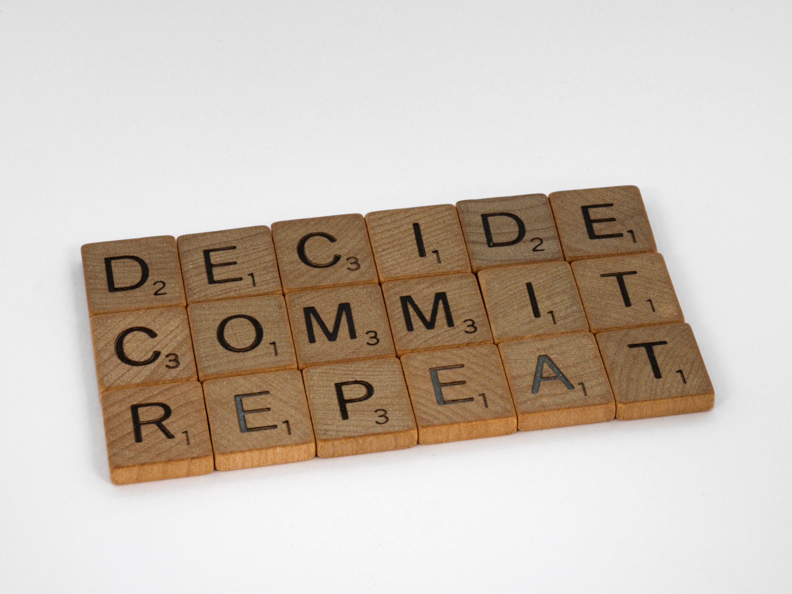 Image showing wooden scrabble tiles that spell out, Decide, Commit, Repeat, to illustrate point about donor retention in respect of an online donation process